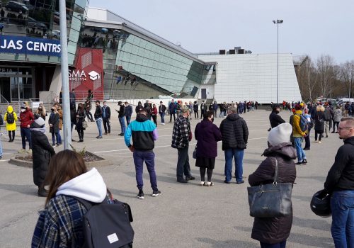 People queue up outside a mass vaccination centre as Latvia opens walk in coronavirus disease (COVID-19) vaccination scheme in Riga, Latvia, April 16, 2021.