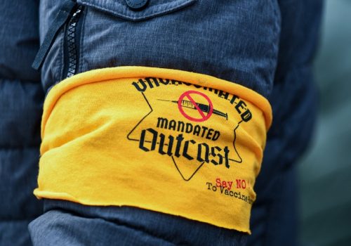 A person wears a yellow arm band with a Star of David during a protest of vaccine mandates at the Lincoln Memorial in Washington, D.C. on January 23, 2022. Anti-vaccine protesters have worn yellow arm bands to compare their current treatment in the United States to the treatment of Jewish people in Germany during the holocaust.