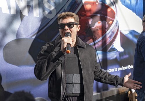 BANNER: Nicholas Fuentes of far-right group America First speaks at an anti-vaccine protest in front of Pfizer world headquarters in New York, November 13, 2021. (Source: Reuters/Ron Adar /SOPA Images/Sipa USA)