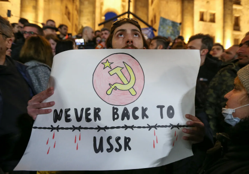 Participants protest against a draft law on “foreign agents” during a rally outside the parliament building in Tbilisi, Georgia, March 8, 2023. (Source: Reuters/Irakli Gedenidze)