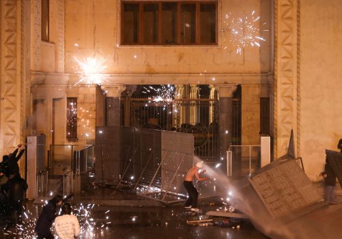 Fireworks explode outside the Georgian parliament building in Tbilisi as protesters attempt to break through barrier constructions during a rally against the bill known as the foreign agents law, March 8, 2023. (Source: Reuters/Irakli Gedenidze)